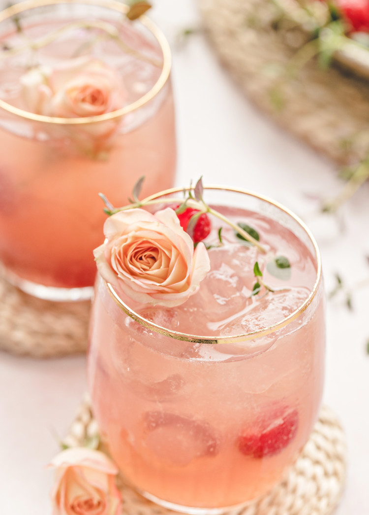photo of two glasses of a floradora cocktail with fresh raspberries