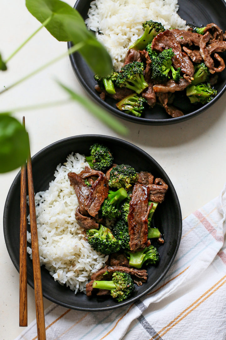 overhead photo of a table set with two servings of chinese beef and broccoli