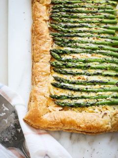 an asparagus tart on a marble board