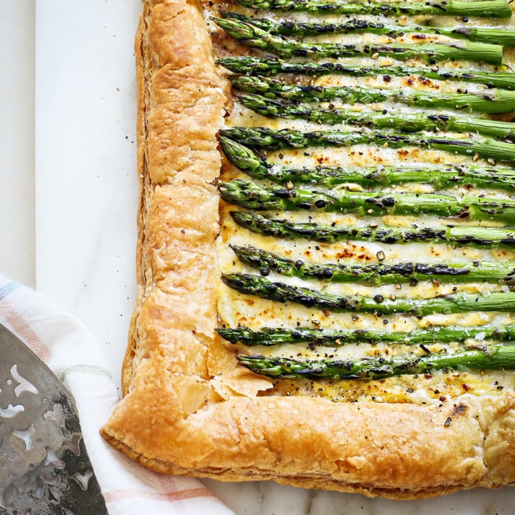 an asparagus tart on a marble board