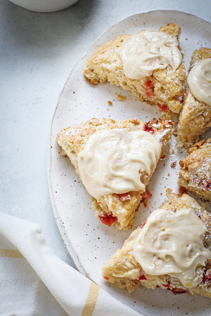 close up of a lemon glazed strawberry scone