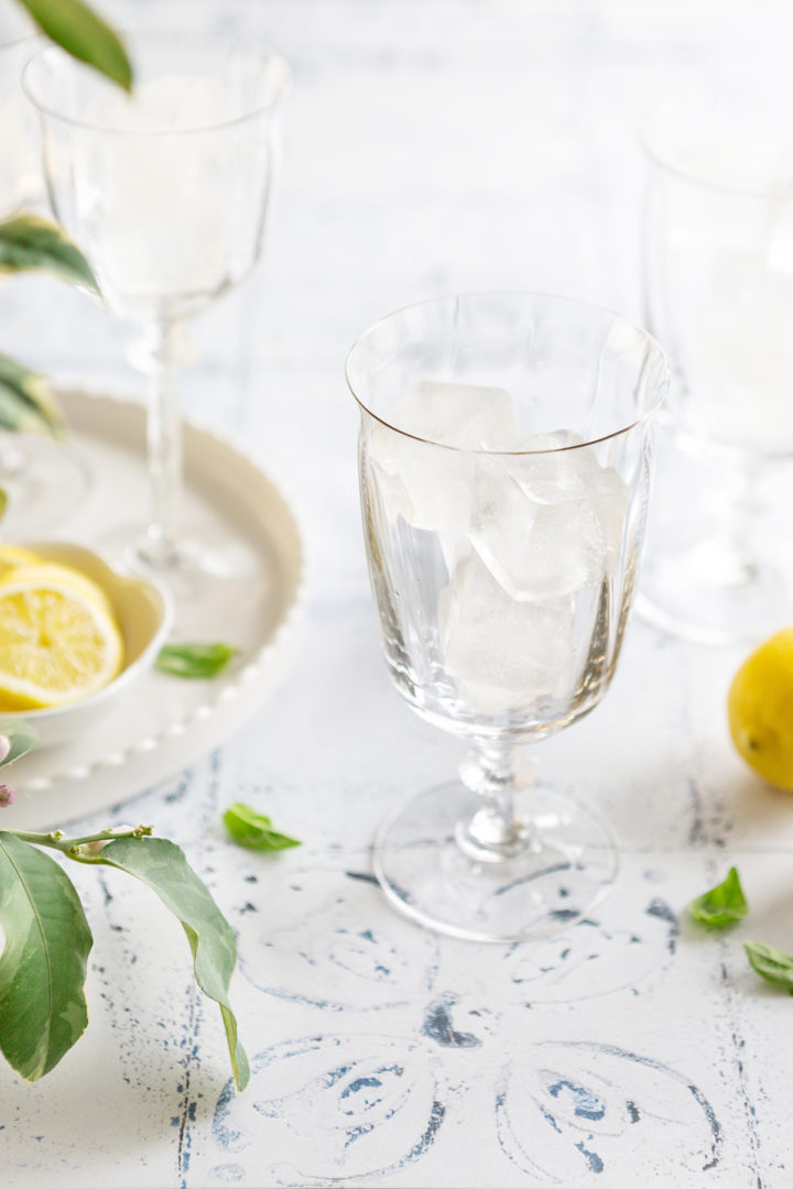 balloon glasses filled with ice ready to be filled with a limoncello prosecco cocktail