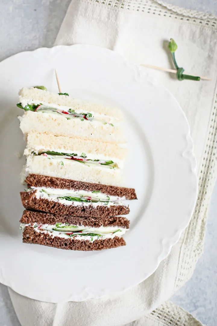 a plate of tea sandwiches for a baby shower using this cucumber watercress sandwich recipe