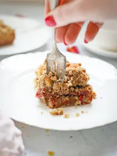 woman eating a slice of rhubarb coffee cake