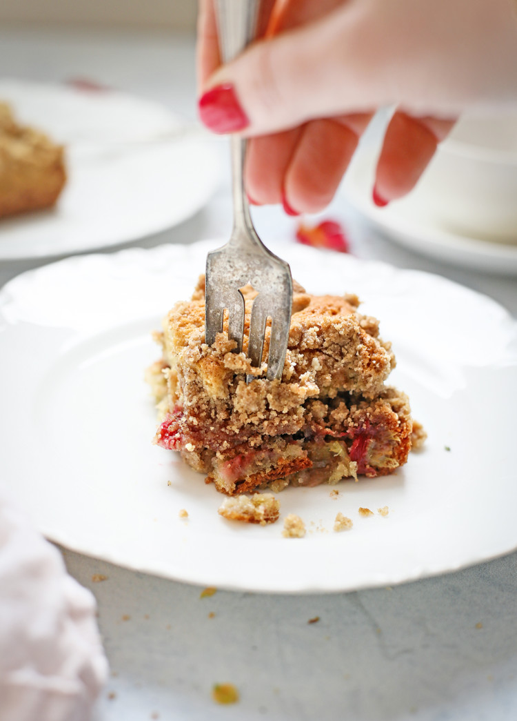 woman eating a slice of rhubarb coffee cake