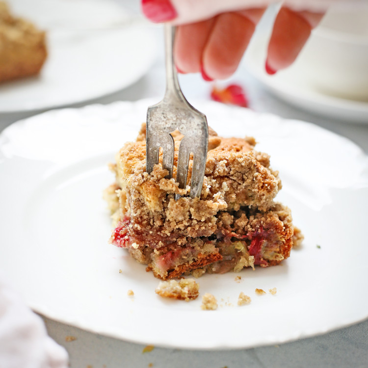 woman eating a slice of rhubarb coffee cake