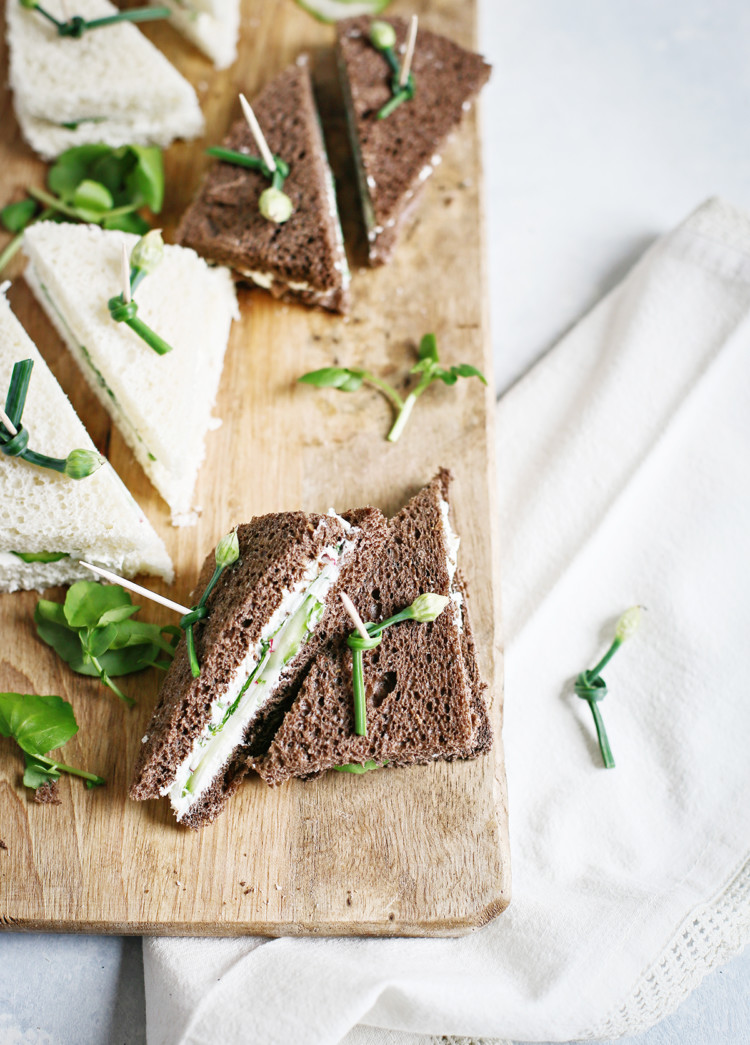 watercress sandwiches on a wooden cutting board