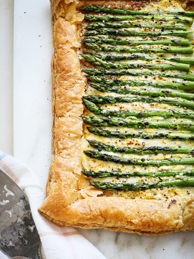 an asparagus tart on a marble board