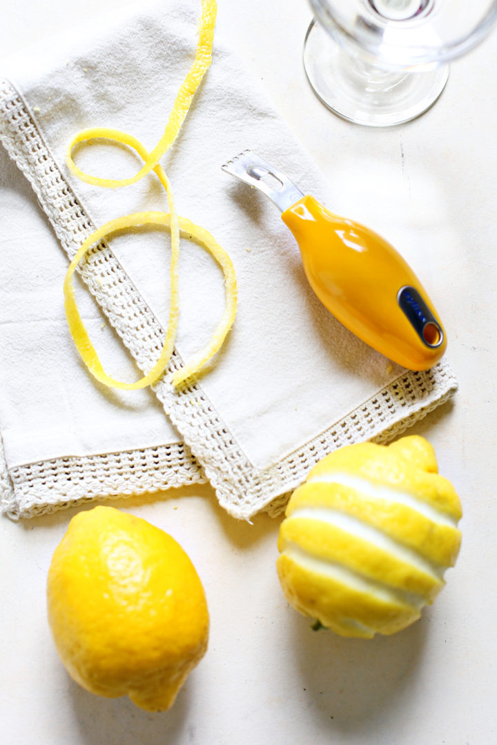 photo showing a twist of lemon next to a channel knife used to make lemon garnishes