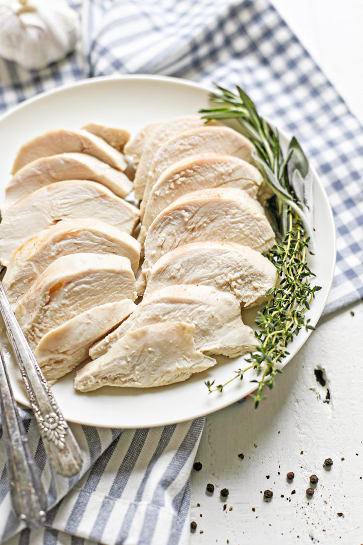 sliced poached chicken on a white plate