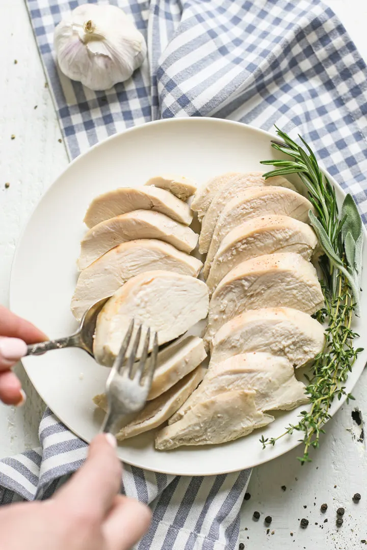woman serving a slice of poached chicken