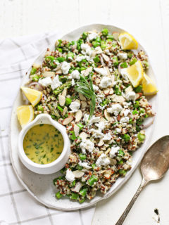 cold asparagus salad with goat cheese on a white platter