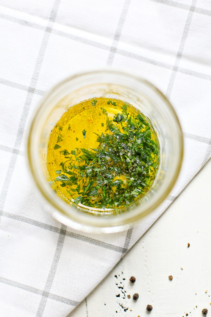 jar with ingredients to make tarragon vinaigrette for cold asparagus salad