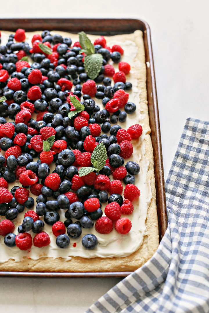 a red white and blue 4th of july dessert with fresh berries on a baking sheet