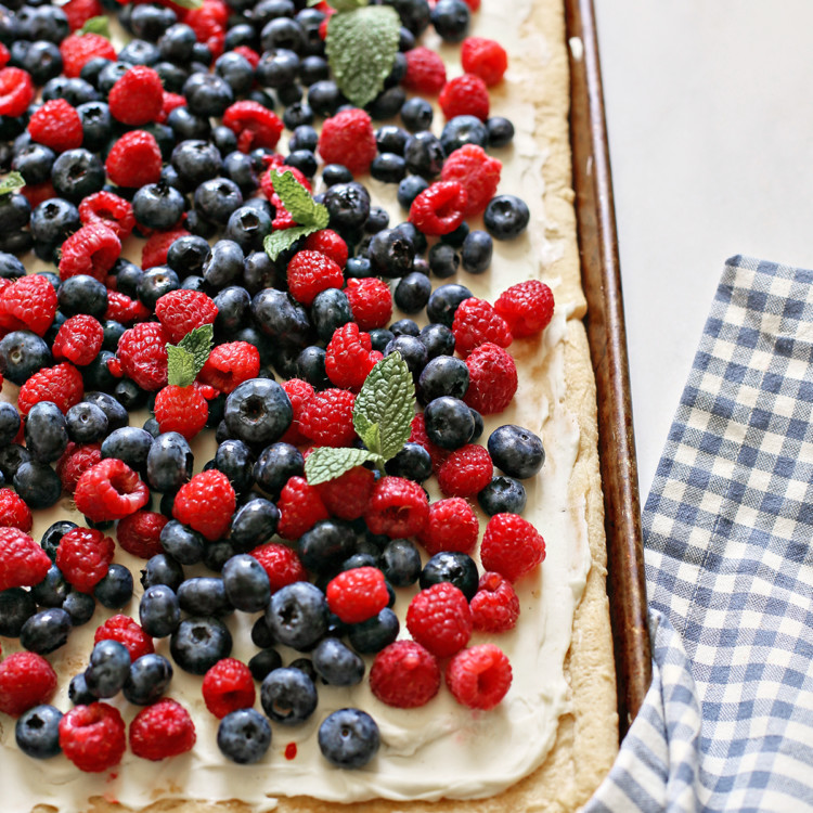 a red white and blue 4th of july dessert with fresh berries on a baking sheet