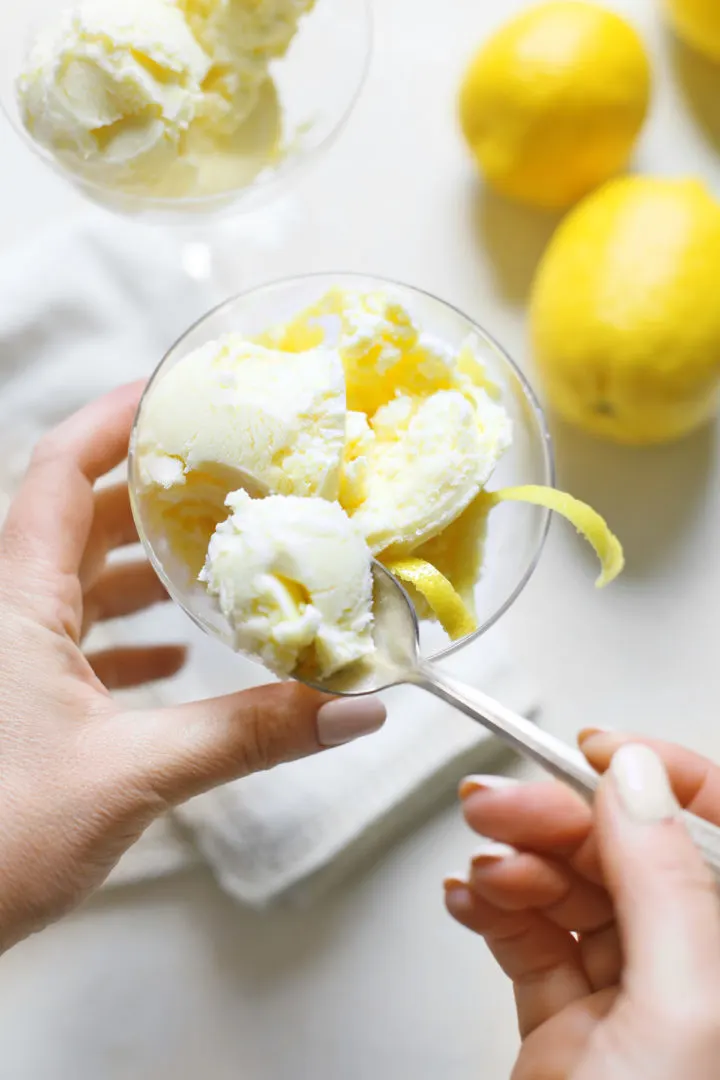woman eating a spoonful of lemon ice cream
