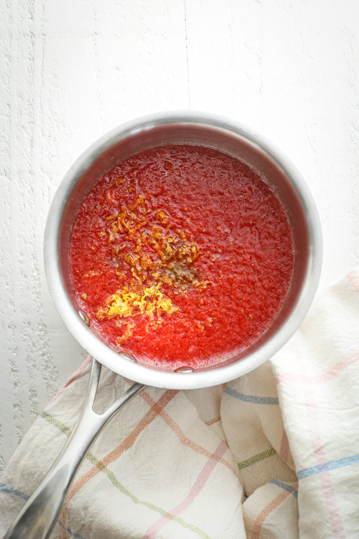 ingredients to make strawberry sauce in a saucepan before cooking