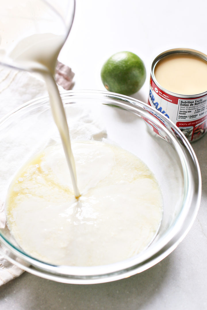 pouring ingredients for key lime pie ice cream recipe into a glass bowl