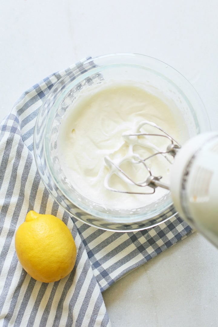 step showing a woman making the cream cheese filling for this 4th of july desserts recipe