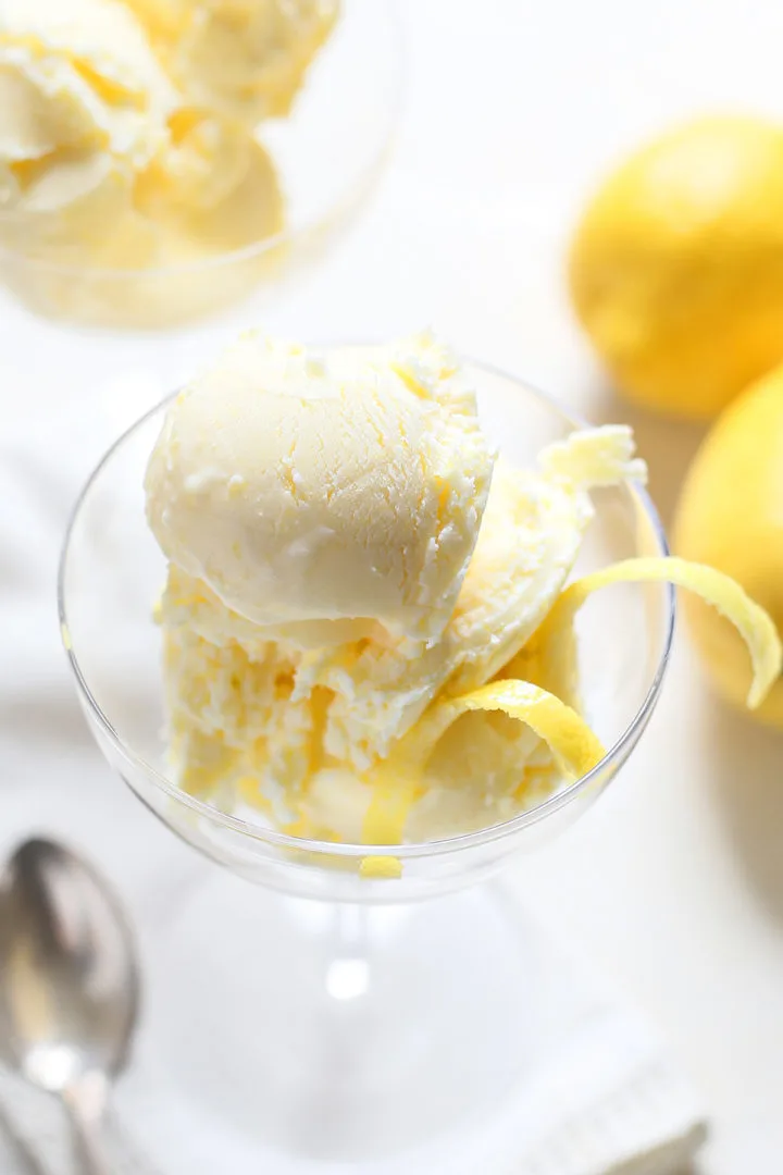 close up of lemon ice cream in a glass dessert dish