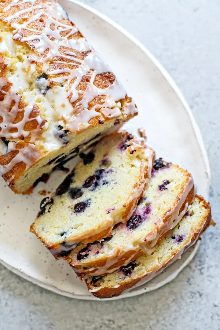 slices of fresh lemon and blueberry bread on a white plate