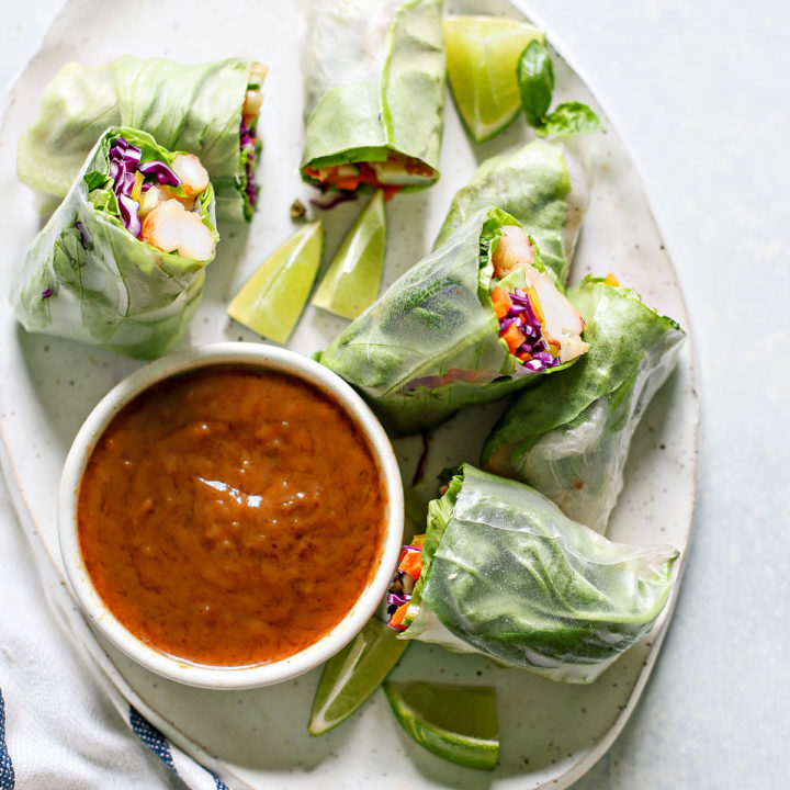 white platter with Vietnamese Spring Rolls and a bowl of peanut dipping sauce