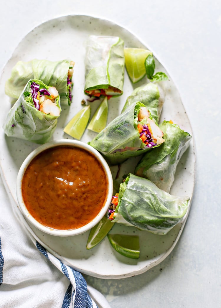 white platter with Vietnamese Spring Rolls and a bowl of peanut dipping sauce