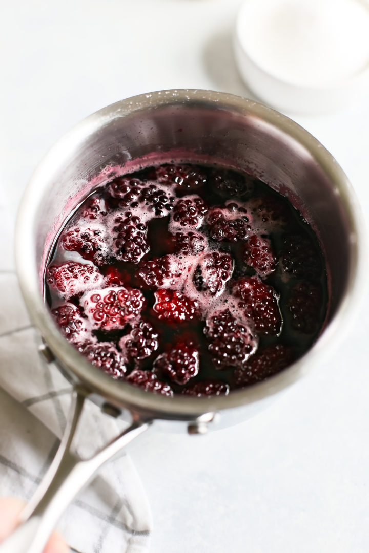 a pot of simple syrup with blackberries after cooking
