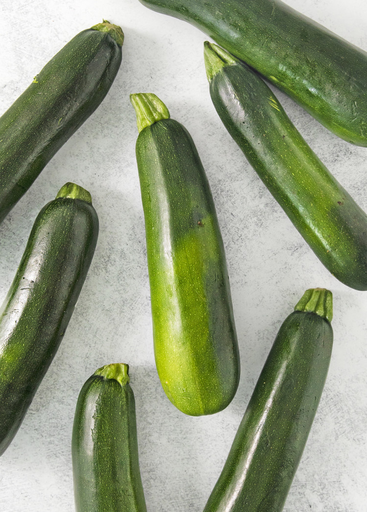 zucchini on a light surface being prepared for freezing