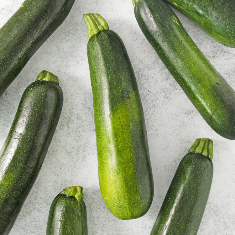 zucchini on a light surface being prepared for freezing