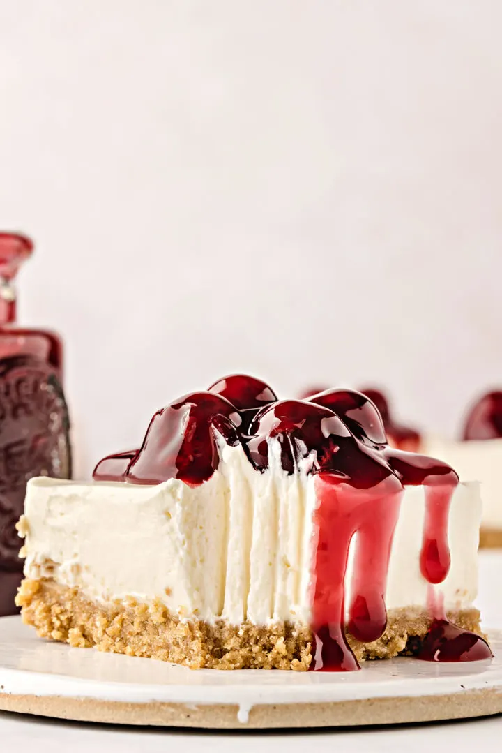 plate with a no bake cheesecake bar with a bite taken out of it