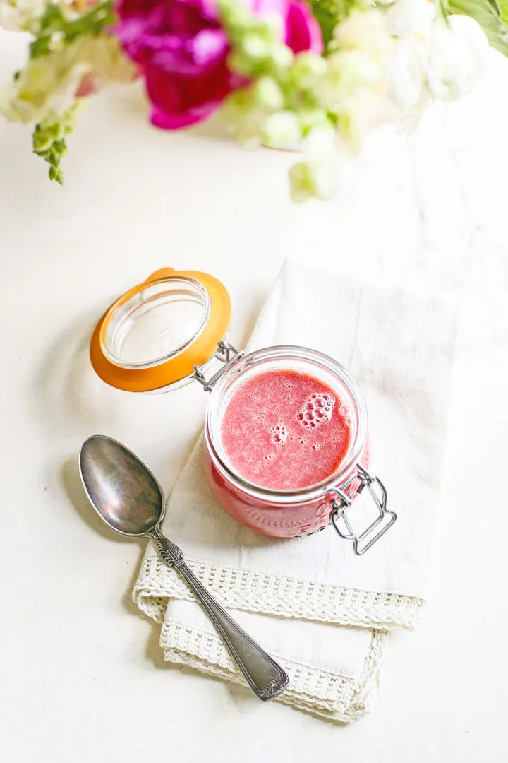photo of a jar of raspberry curd with a spoon
