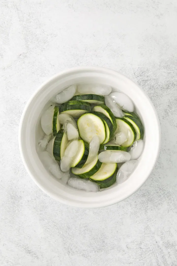blanched zucchini in an ice bath