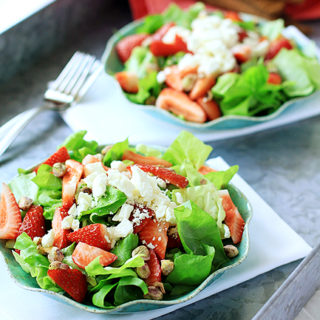 plates of strawberry goat cheese salad on a serving tray