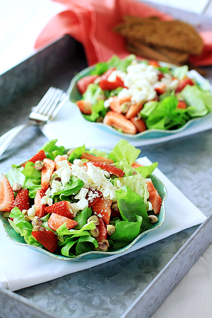 plates of strawberry goat cheese salad on a serving tray