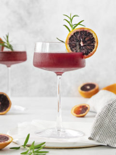 blood orange whiskey sour close up in a coupe glass