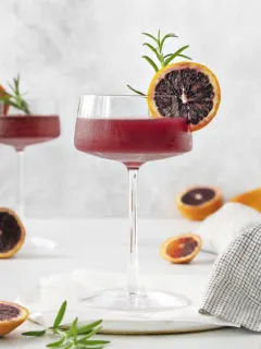 blood orange whiskey sour close up in a coupe glass