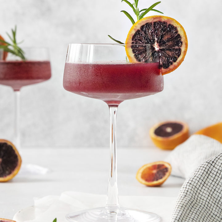 blood orange whiskey sour close up in a coupe glass