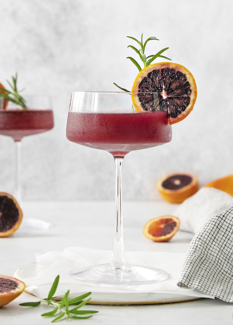 blood orange whiskey sour close up in a coupe glass