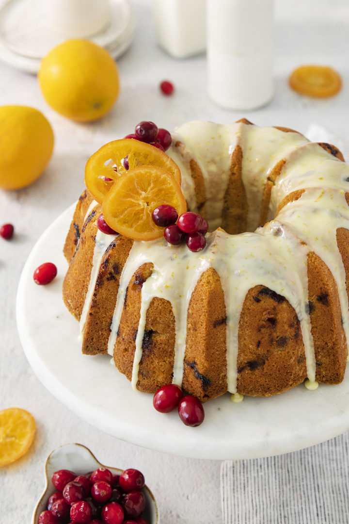 close up photo of a glazed orange cranberry bundt cake	