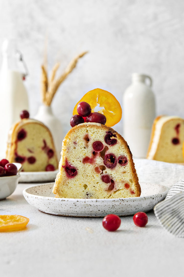 a slice of cranberry orange bundt cake on a plate