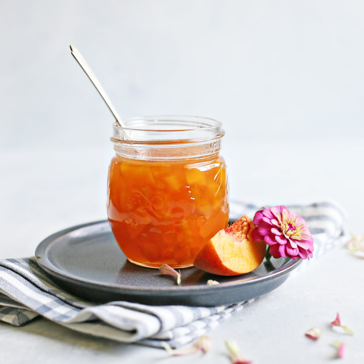 homemade peach syrup in a jar