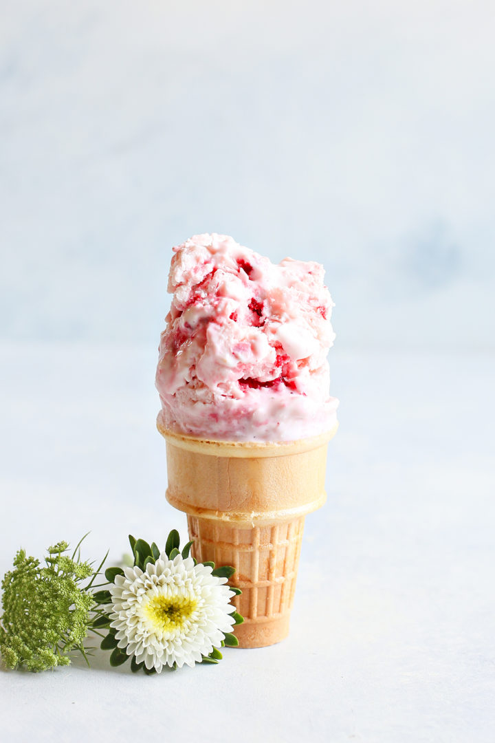 strawberry frozen yogurt on an ice cream cone