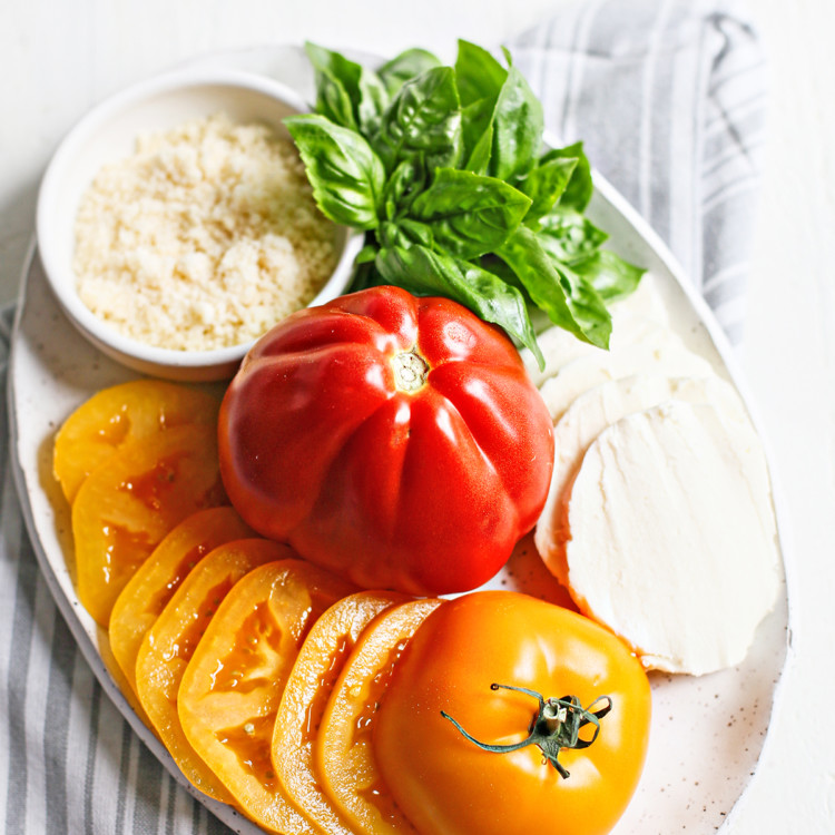 fresh tomatoes on a white platter
