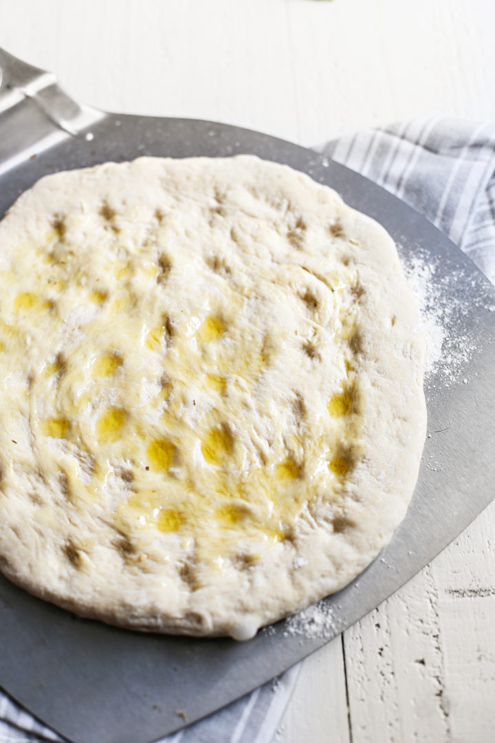 olive oil drizzled on top of the focacca pizza dough