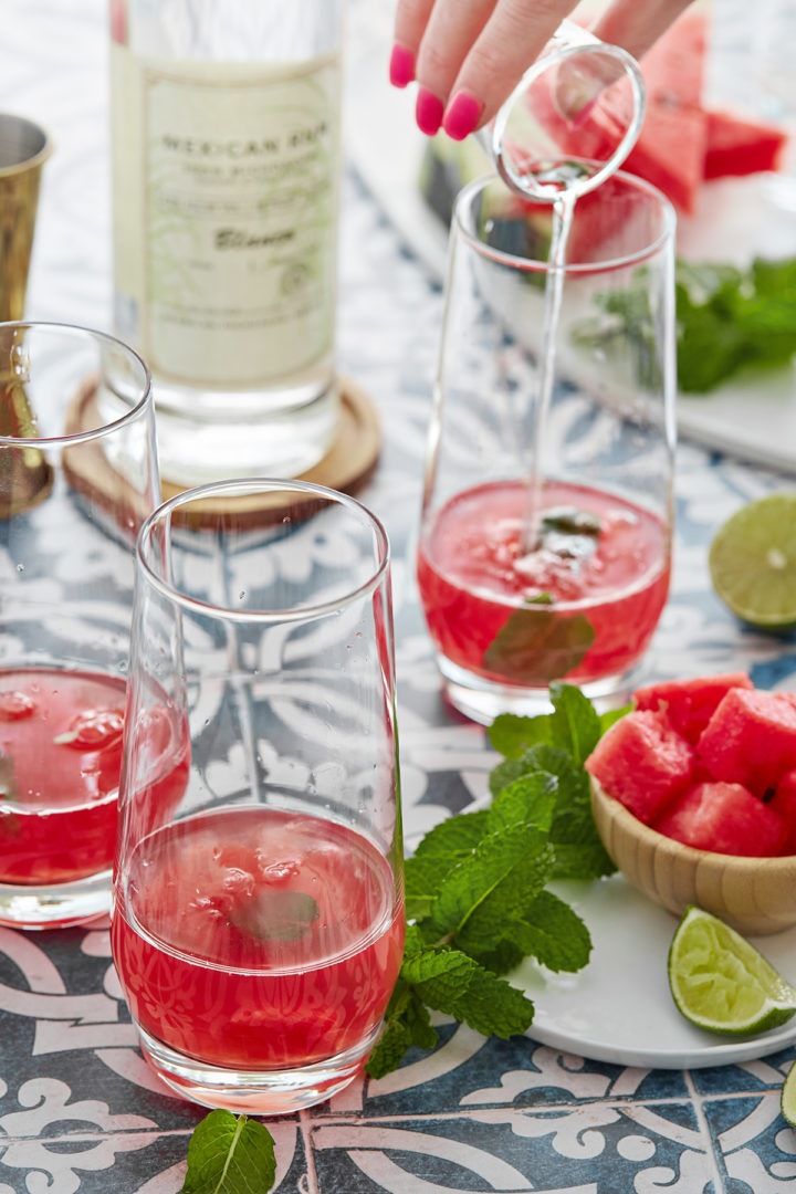 woman showing how to make a watermelon mojito recipe