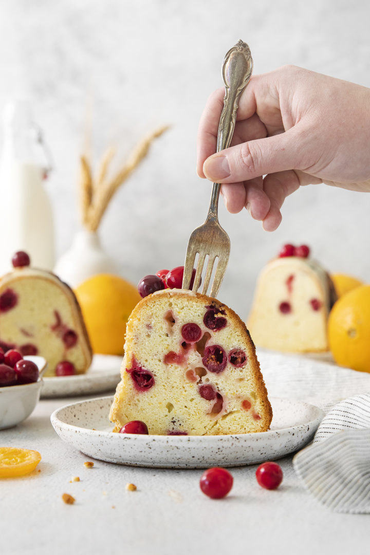 woman eating a bite of cranberry orange cake	