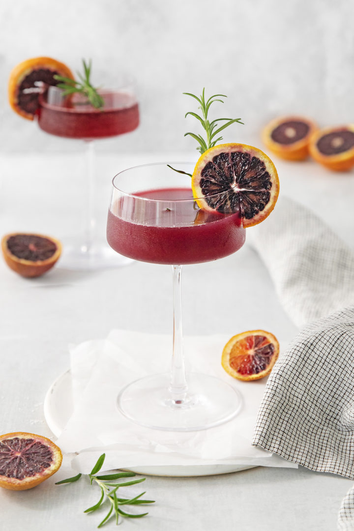 blood orange whiskey sours read to serve on a white background