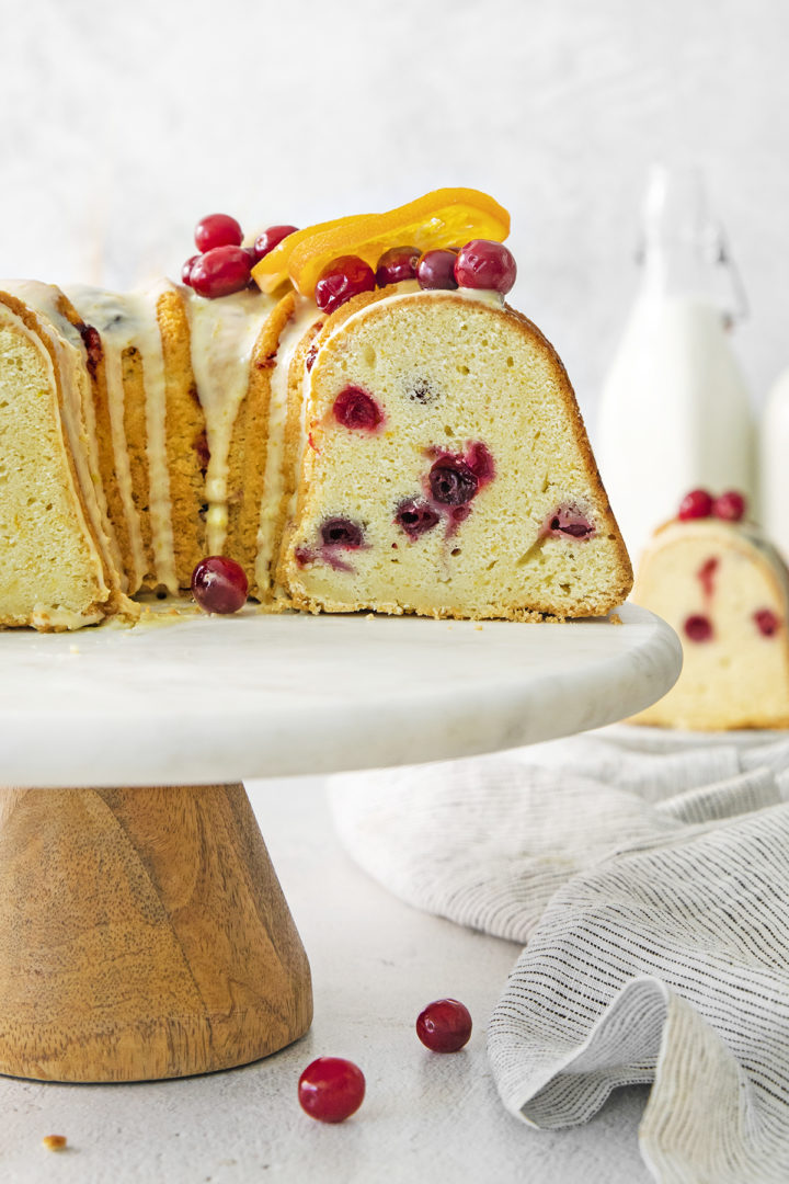 a sliced cranberry orange cake on a cake stand