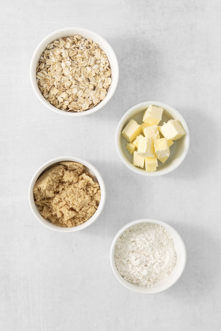 apple crumble muffin topping ingredients in bowls on a light grey background
